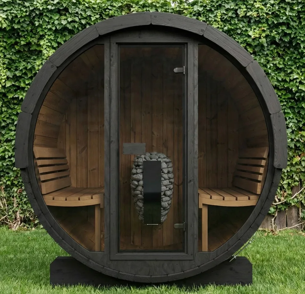 Dark-stained barrel sauna with a glass front standing on a lawn in front of an ivy hedge
